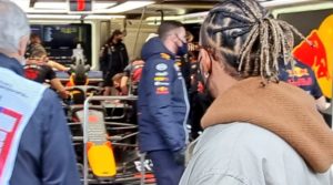 Lewis Hamilton wanders along the pit lane to spy on competitors including Red Bull